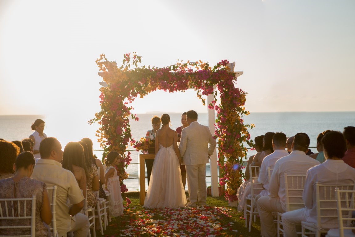 sunset destination wedding with flowers on beach